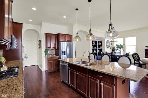 Kitchen at 10001 Copper Saddle Bend, Fishers, IN — Spacious kitchen with granite island and premium finishes.