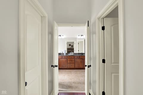 Hallway at 10001 Copper Saddle Bend, Fishers, IN — Elegant hallway with double doors and updated fixtures.