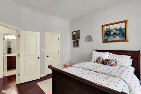 Bedroom at 10001 Copper Saddle Bend, Fishers, IN — Spacious bedroom with hardwood floors and ensuite access.