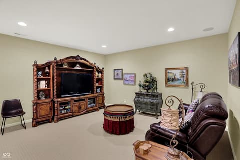 Family room at 10001 Copper Saddle Bend, Fishers, IN — Spacious family room with custom entertainment center.