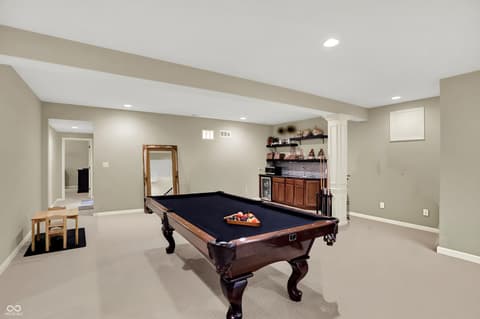 Bonus room at 10001 Copper Saddle Bend, Fishers, IN — Spacious finished basement recreation room with wet bar.