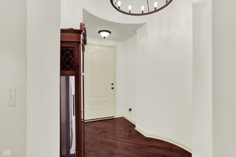 Foyer at 10001 Copper Saddle Bend, Fishers, IN — Bright foyer with soaring ceiling and hardwood floors.