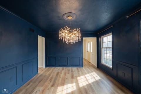 Foyer at 72 Ashbourne Drive, Noblesville, IN — Elegant foyer with crystal chandelier and wainscoting.