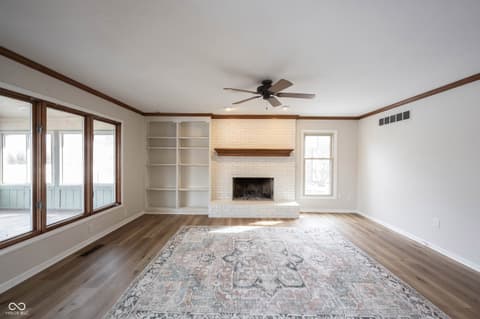 Living room at 72 Ashbourne Drive, Noblesville, IN — Spacious living room with fireplace and built-in shelving.