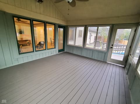 Outdoor living area at 72 Ashbourne Drive, Noblesville, IN — Spacious covered deck with extensive glass and yard views.