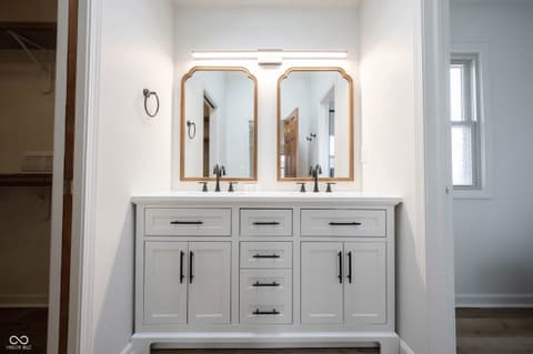 Primary bathroom at 72 Ashbourne Drive, Noblesville, IN — Spa-like primary bath with dual vanity and designer mirrors.