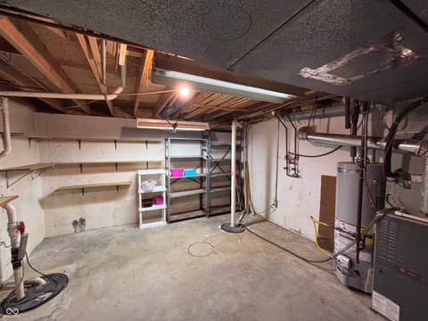 Garage at 72 Ashbourne Drive, Noblesville, IN — Spacious garage with storage shelving and utility systems.