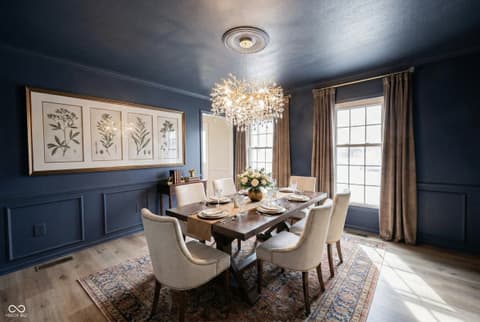 Dining room at 72 Ashbourne Drive, Noblesville, IN — Elegant dining room with wainscoting and crystal chandelier.