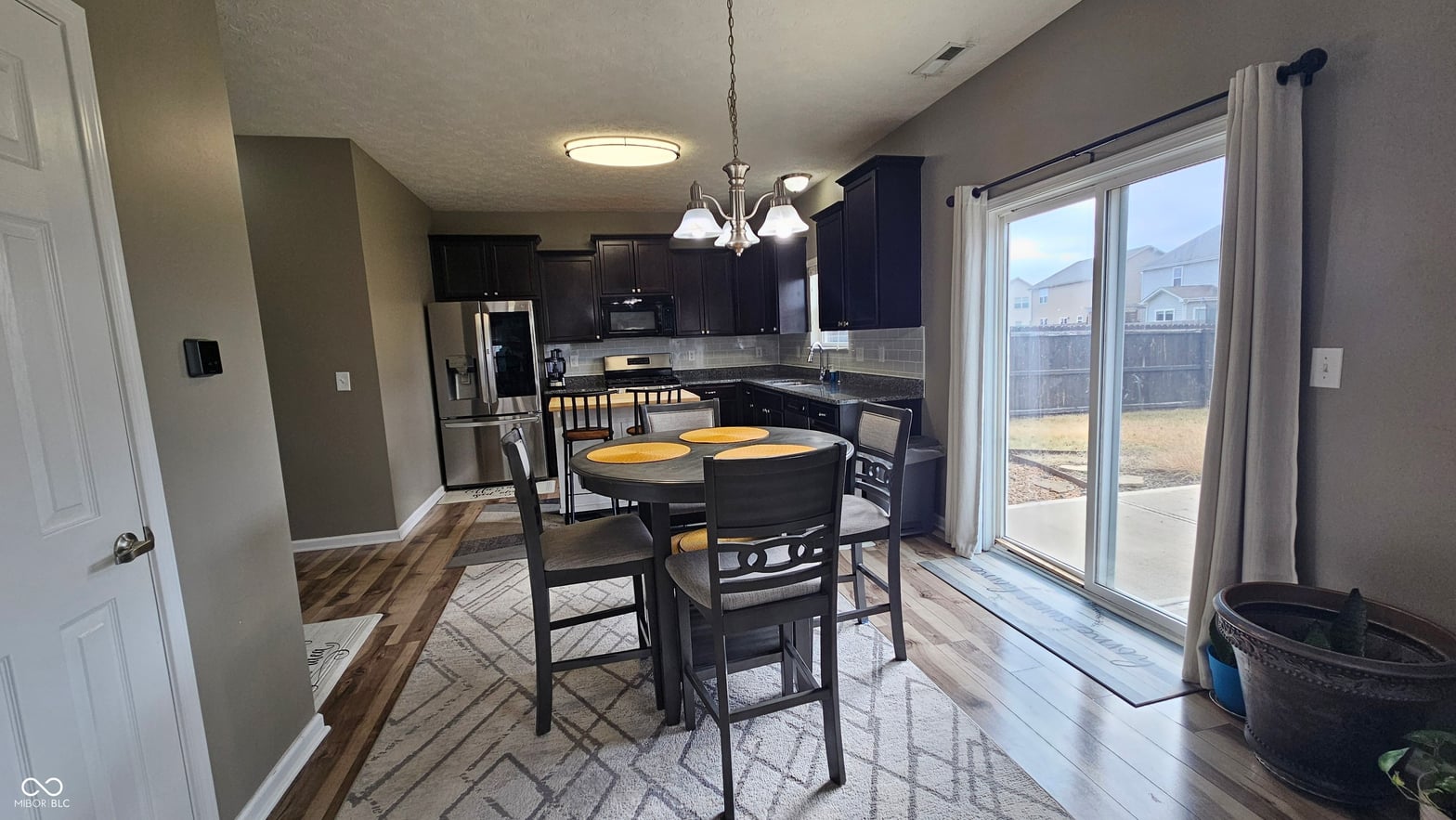 Bright open dining area with backyard patio access.