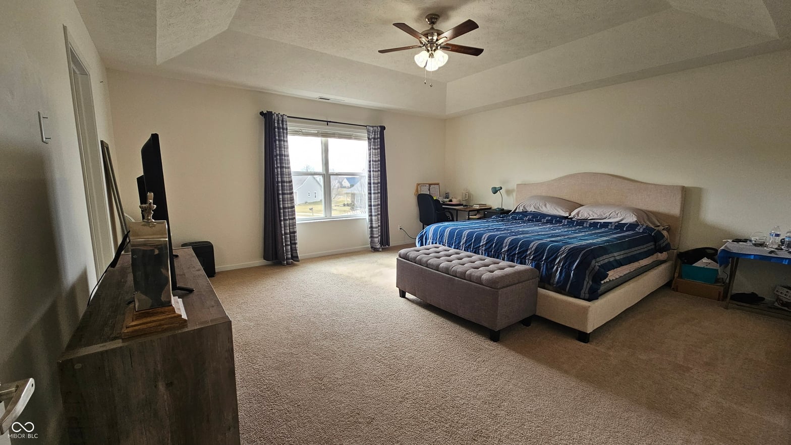 Spacious primary bedroom with abundant natural light.