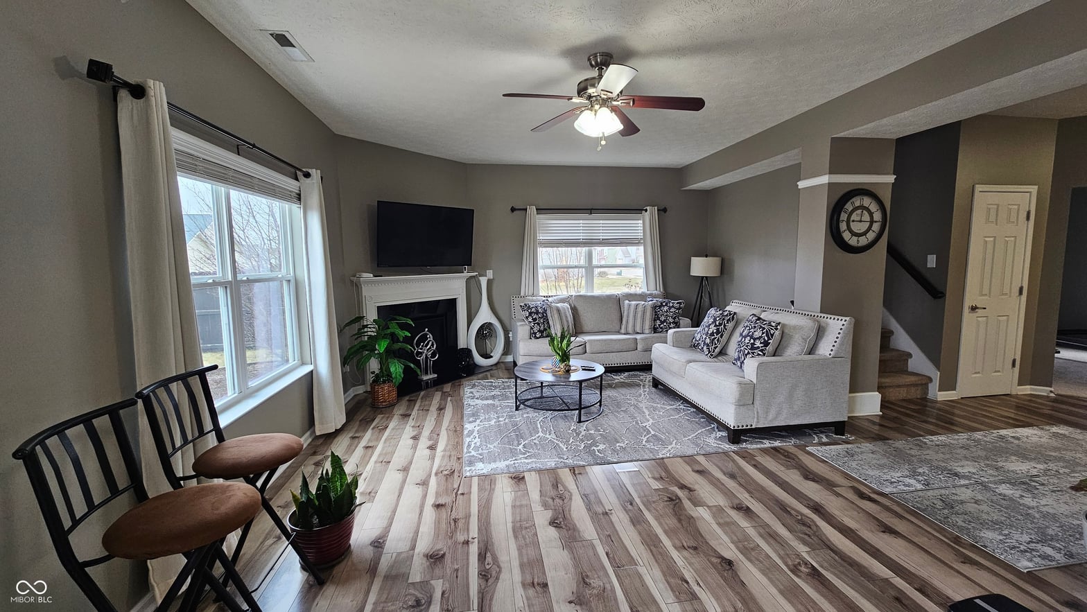 Bright, spacious living room with fireplace and open layout.