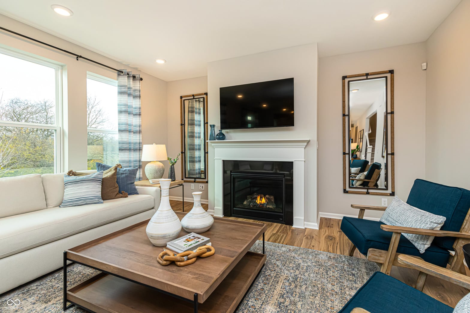 Spacious living room with gas fireplace and modern finishes.