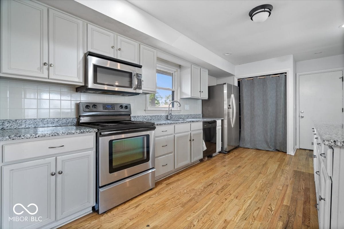 Updated kitchen with granite counters and stainless steel appliances.