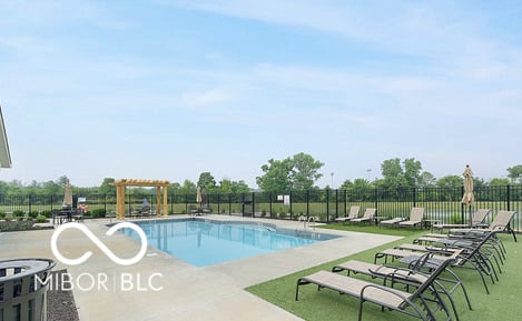 Resort-style community pool with ample lounge seating.