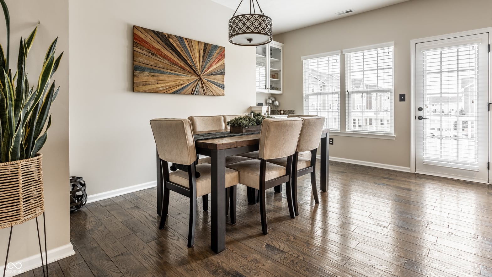 Bright dining area with hardwood floors and glass doors.