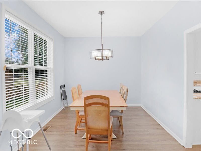 Bright dining room with plantation shutters and natural light.