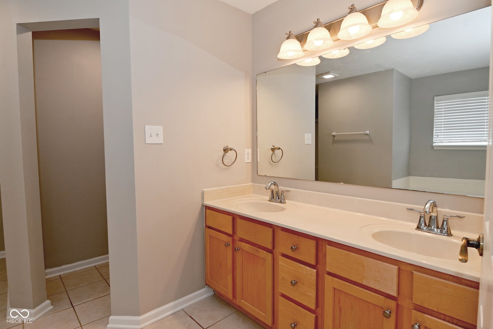 Spacious primary bath with dual vanity and updated fixtures.