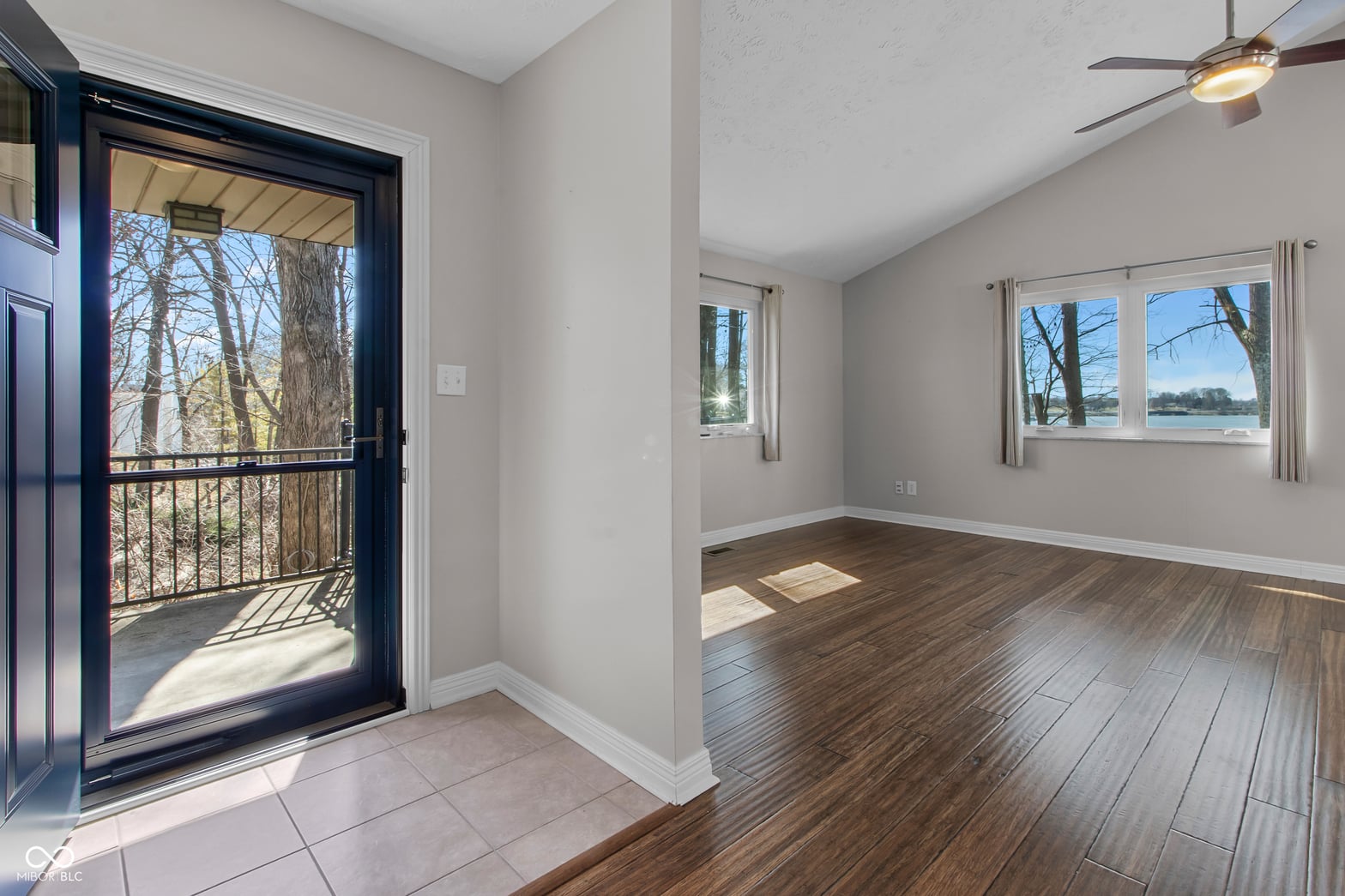 Bright living space with water views and deck access.
