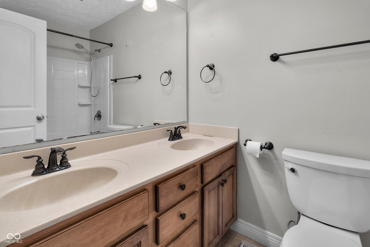 Spacious primary bath with dual vanity and soaking tub.