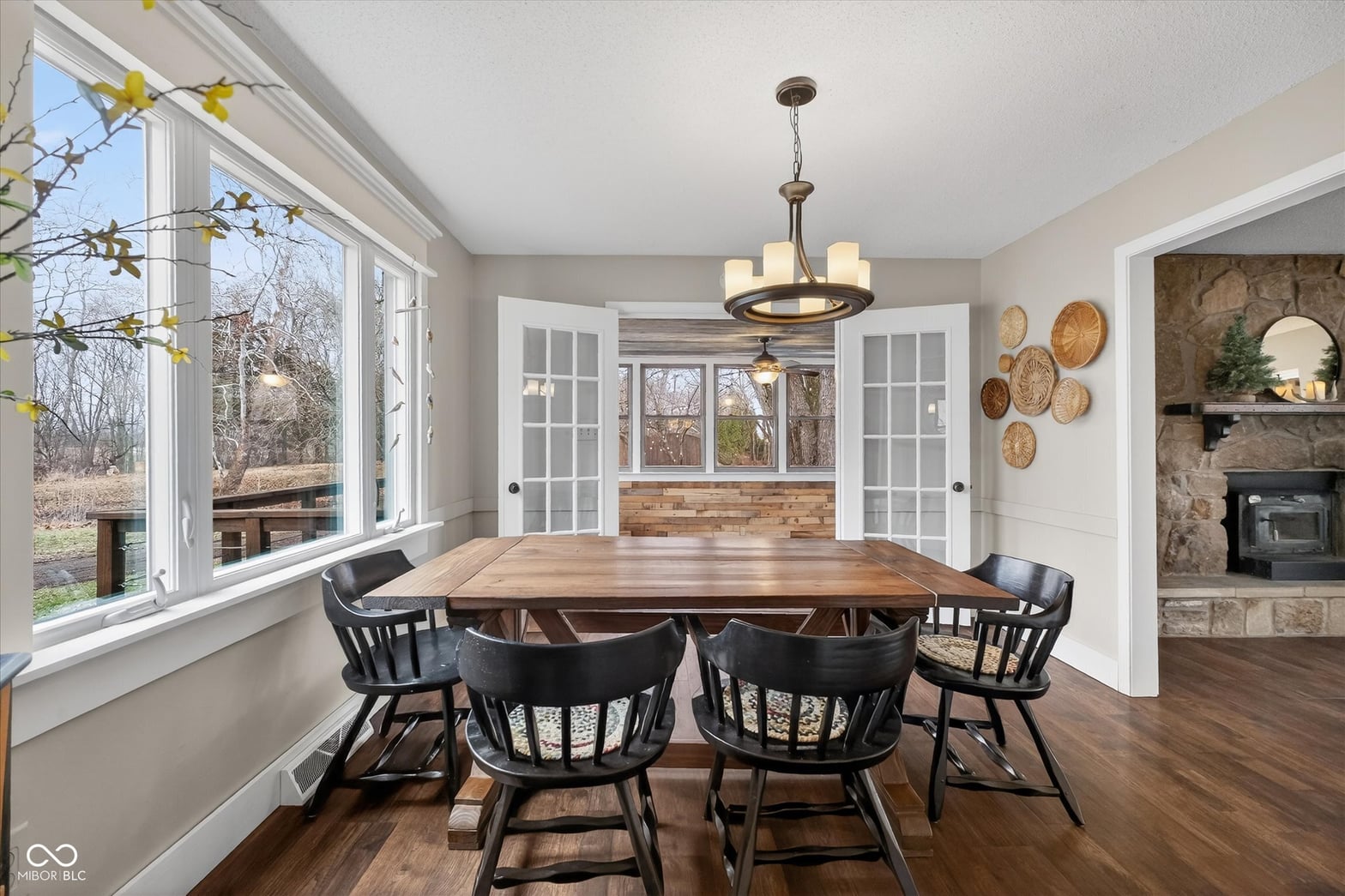 Bright dining room with fireplace and French doors.