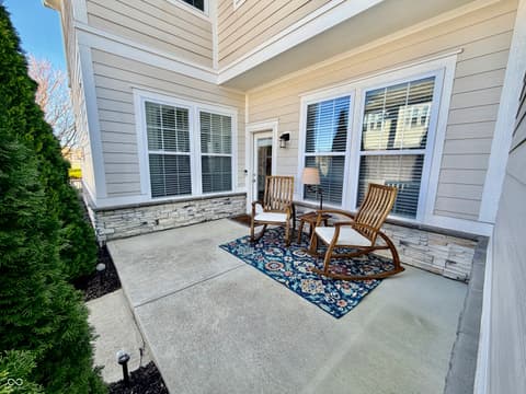 Outdoor living area at 13201 E 131st Street, Fishers, IN — Spacious covered patio with modern finishes and seating.
