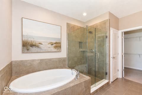 Primary bathroom at 13201 E 131st Street, Fishers, IN — Spa-like primary bath with soaking tub and frameless shower.