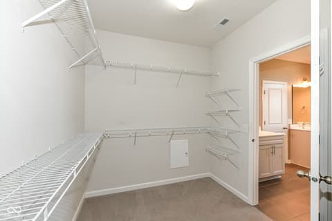 Laundry room at 13201 E 131st Street, Fishers, IN — Spacious laundry room with ample wire shelving and storage.