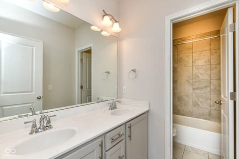 Primary bathroom at 13201 E 131st Street, Fishers, IN — Spacious primary bath with dual vanity and tiled shower.