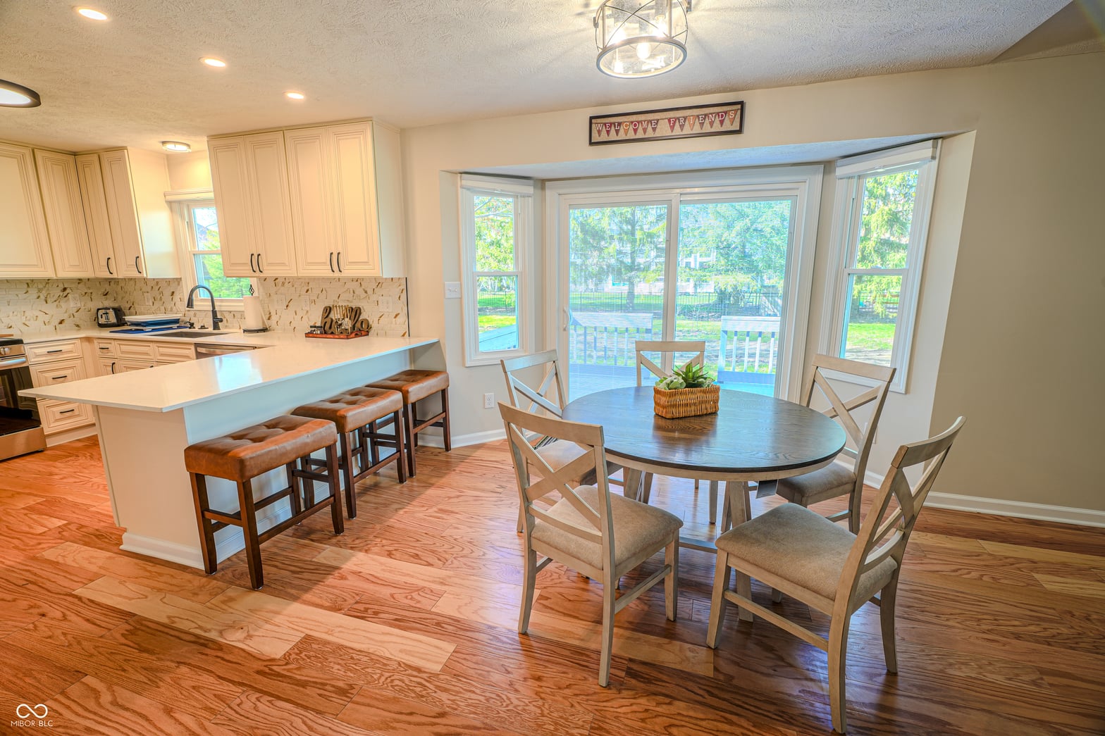 Bright open kitchen with island overlooking backyard.