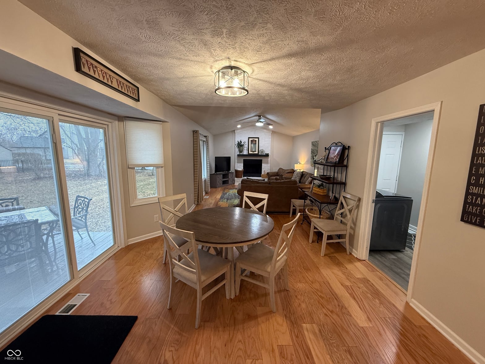 Bright dining area with hardwood floors and outdoor access.