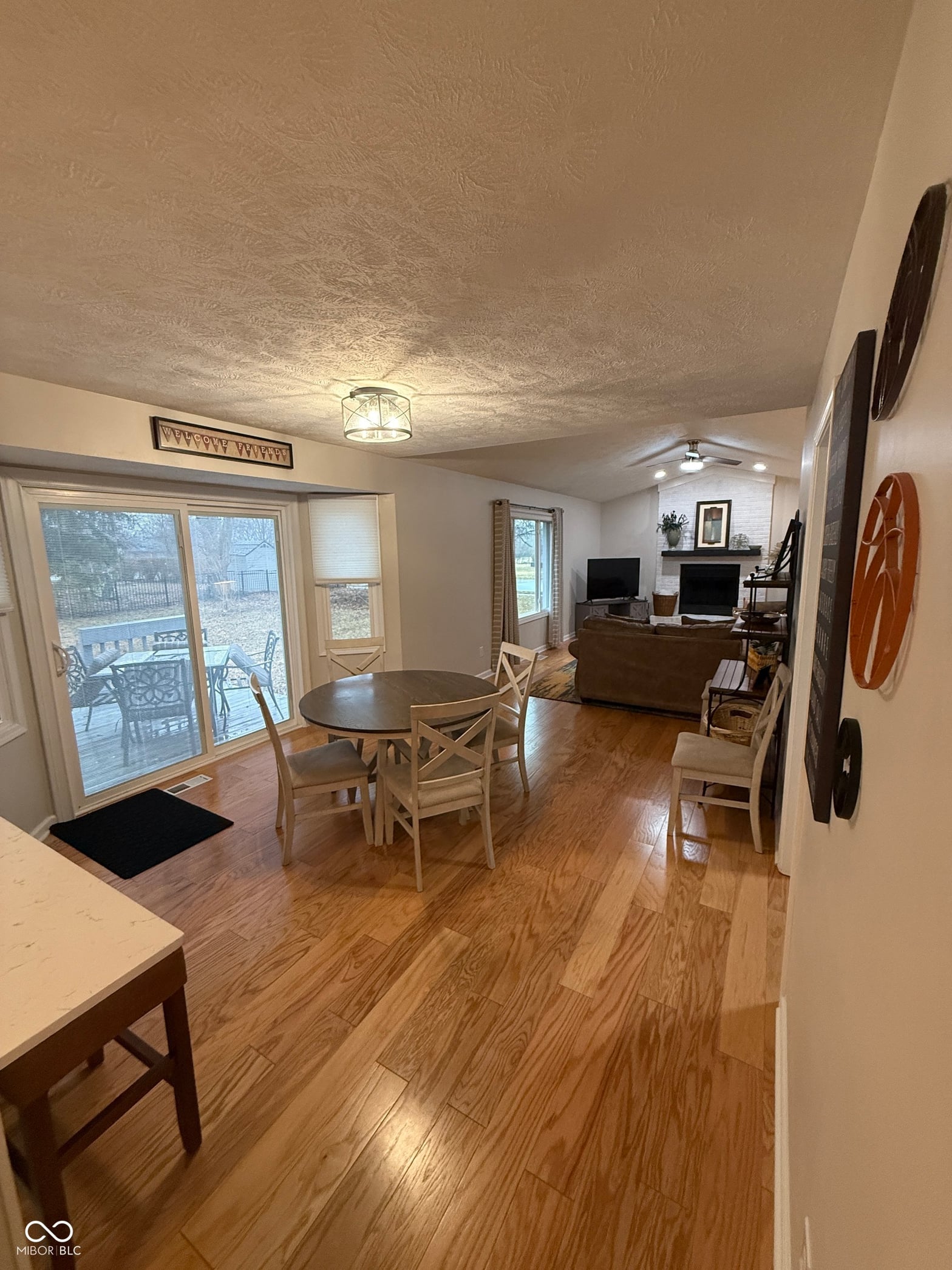 Open living space with hardwood floors and deck access.