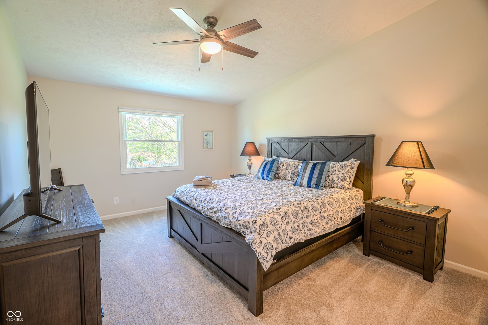 Spacious primary bedroom with abundant natural light and modern amenities.