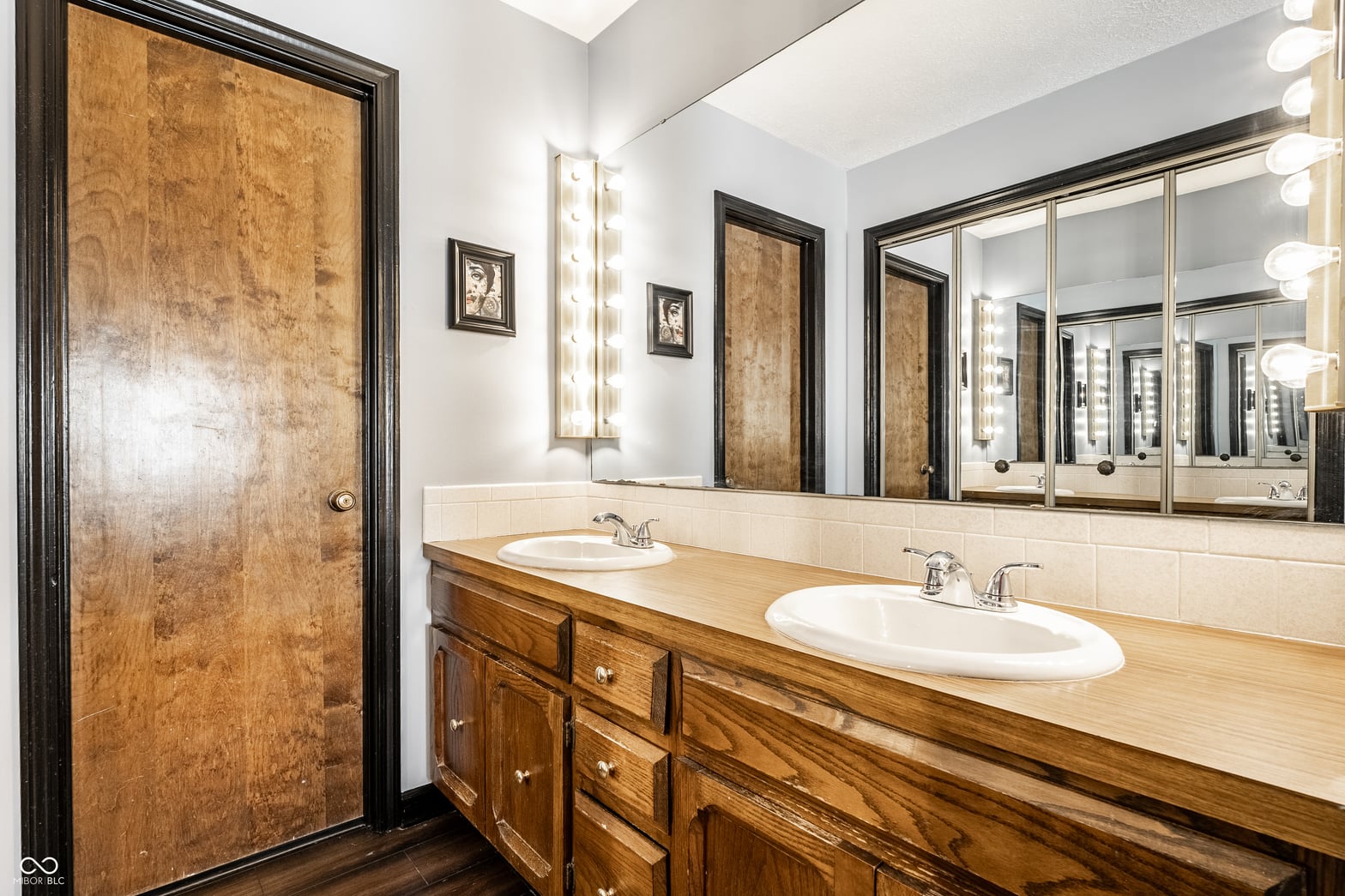 Spacious primary bath with dual sinks and custom wood vanity.