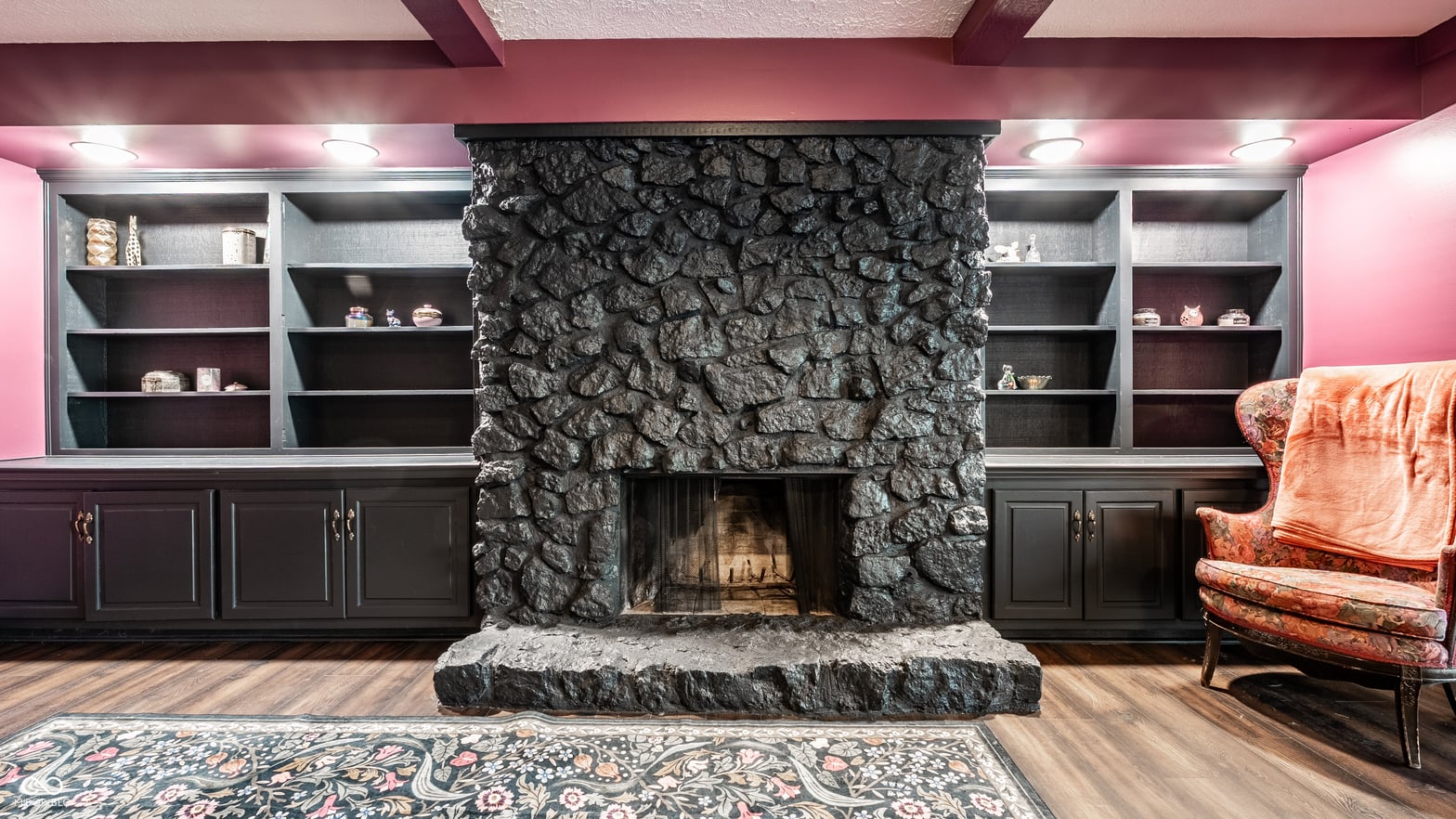 Stunning stone fireplace with custom built-in shelving.