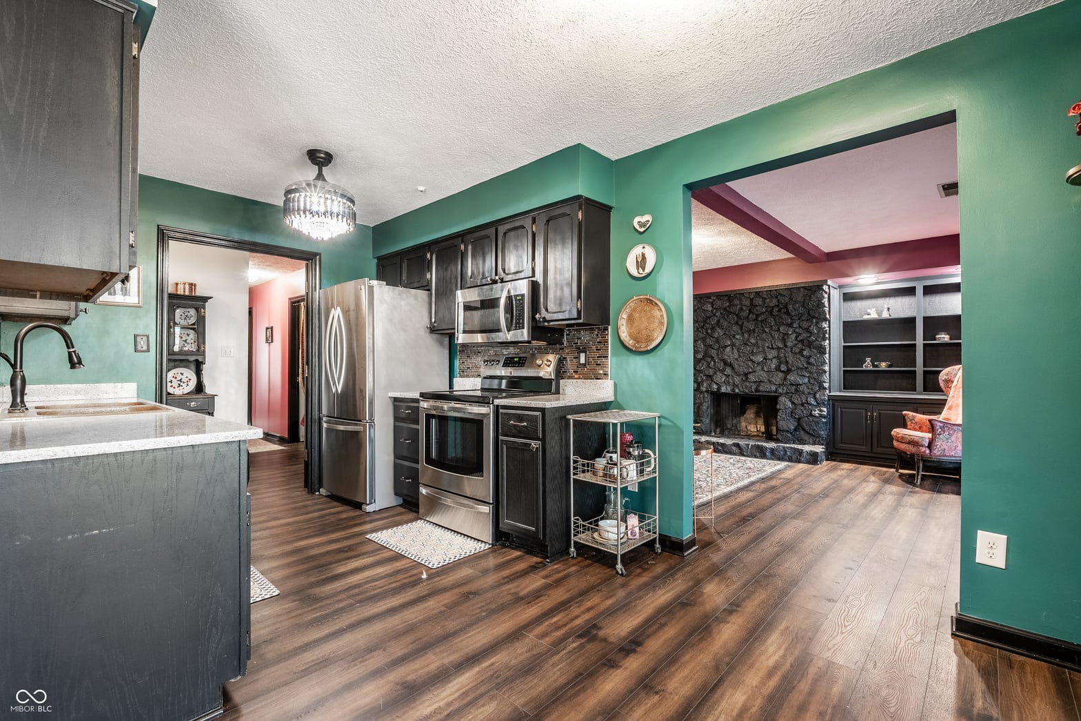 Renovated kitchen with open floor plan and fireplace.