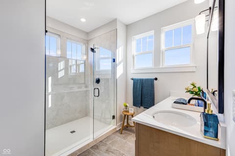 Primary bathroom at 15709 Showdown Road, Noblesville, IN — Spa-like primary bath with frameless shower and soaking tub.