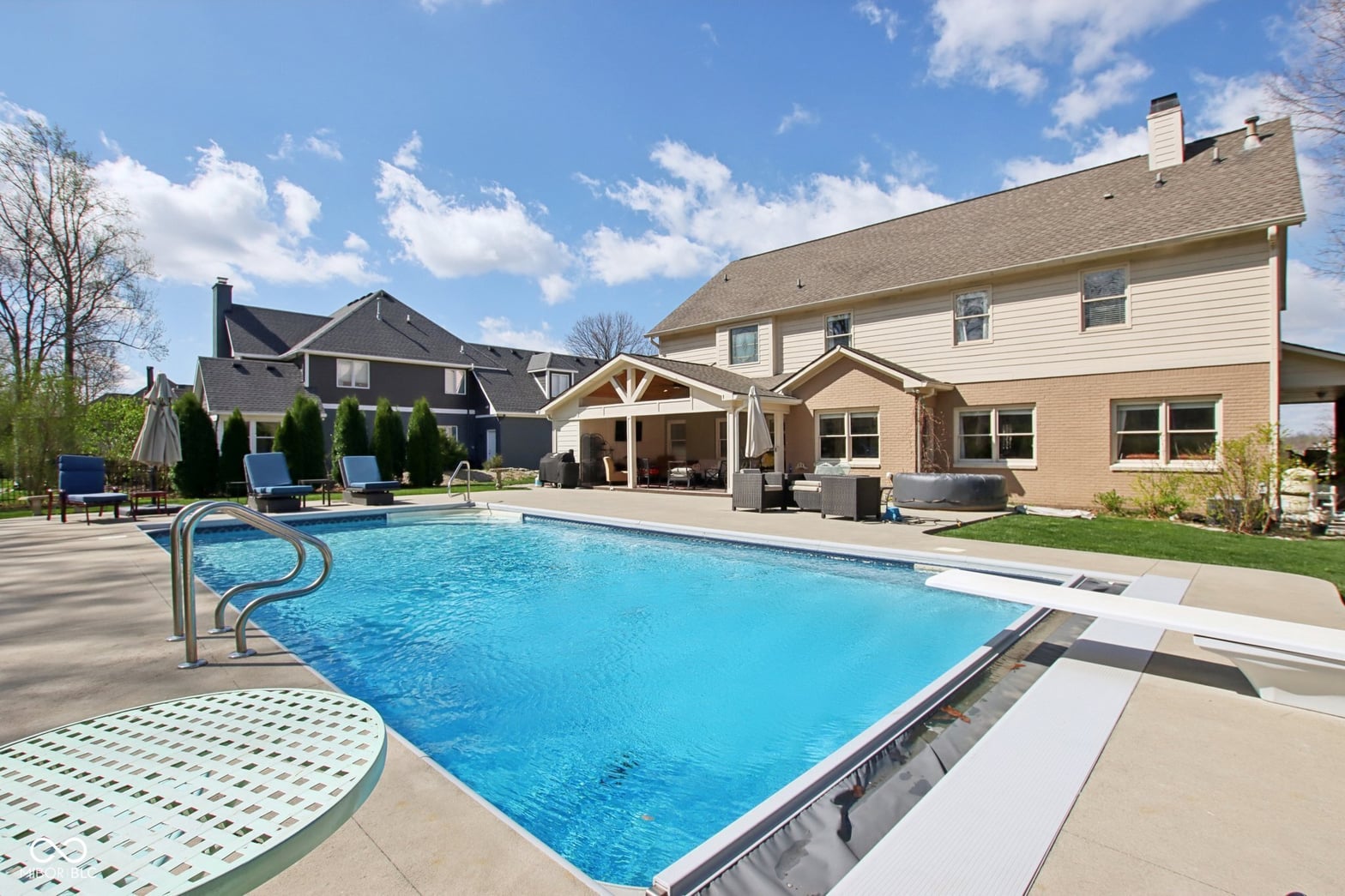 Resort-style pool with covered patio and lounging areas.