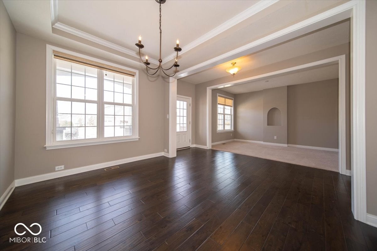 Spacious living room with coffered ceilings and hardwood floors.