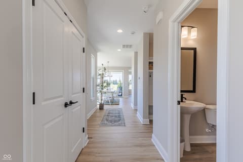 Hallway at 15732 Showdown Road, Noblesville, IN — Bright hallway with hardwood floors and modern finishes.