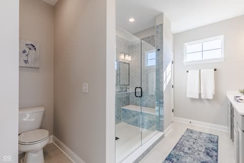 Primary bathroom at 15732 Showdown Road, Noblesville, IN — Luxurious primary bath with spa-like walk-in shower.