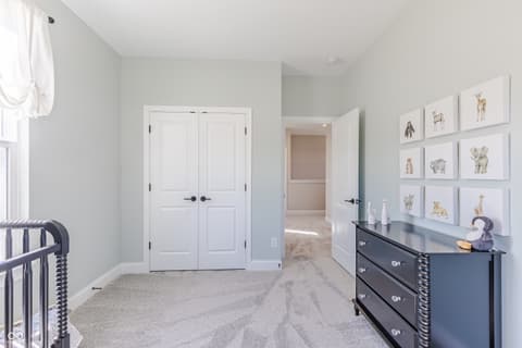 Primary bedroom at 15732 Showdown Road, Noblesville, IN — Bright primary suite with ample closet and gallery wall.