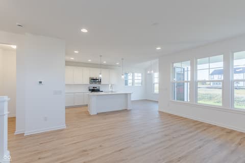 Kitchen at 15752 Showdown Road, Noblesville, IN — Bright modern kitchen with island and expansive windows.