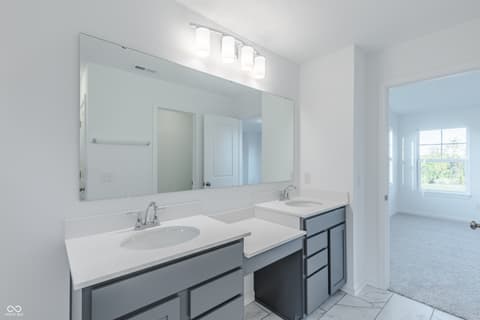 Primary bathroom at 15752 Showdown Road, Noblesville, IN — Spacious primary bath with dual vanity and frameless mirror.