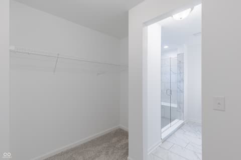Primary bathroom at 15752 Showdown Road, Noblesville, IN — Spacious primary bath with walk-in closet and glass shower.