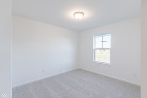 Bedroom at 15752 Showdown Road, Noblesville, IN — Bright bedroom with large window and fresh carpet.