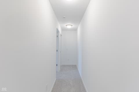 Hallway at 15752 Showdown Road, Noblesville, IN — Bright, modern hallway with fresh carpet and clean finishes.