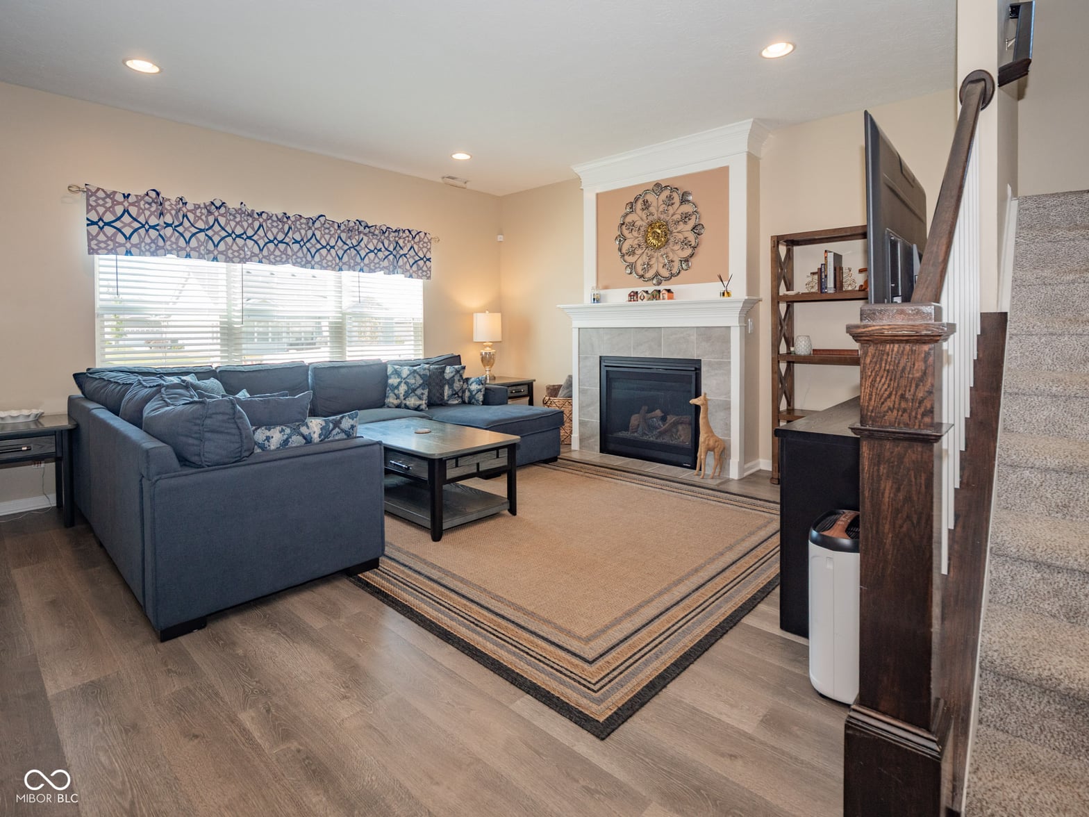 Spacious living room with fireplace and modern updates.