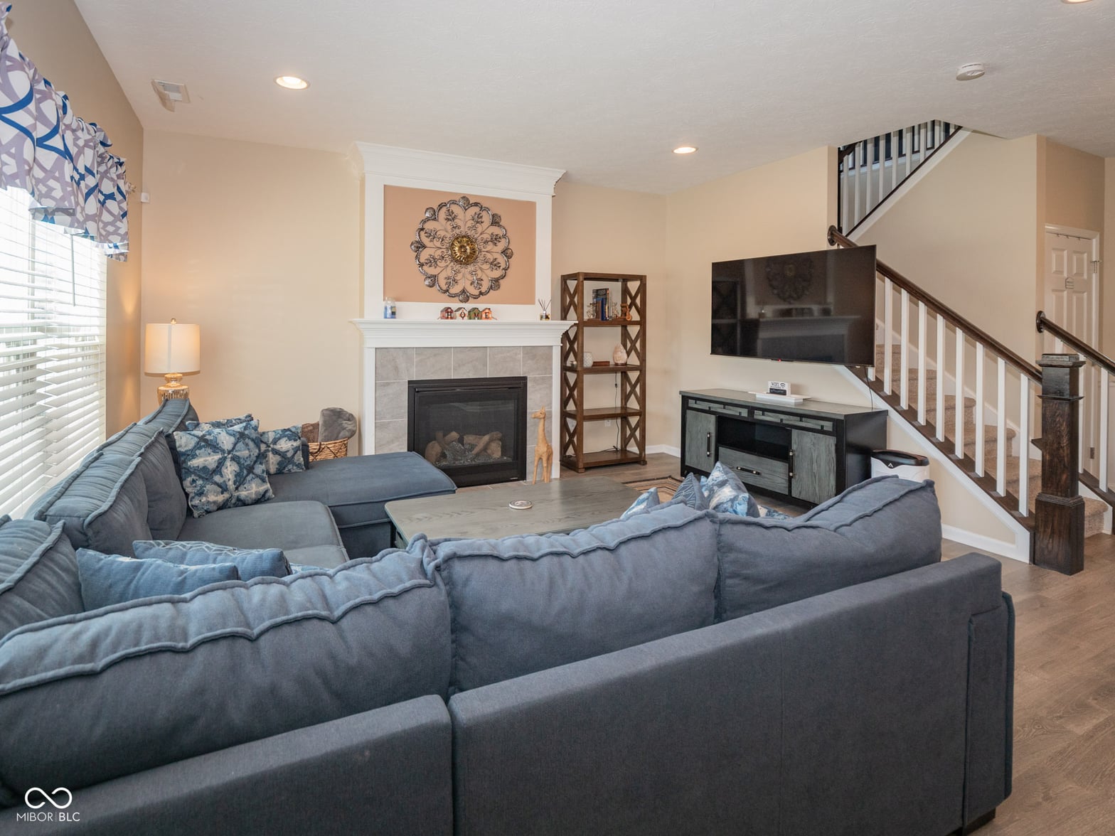 Spacious family room with fireplace and entertainment center.