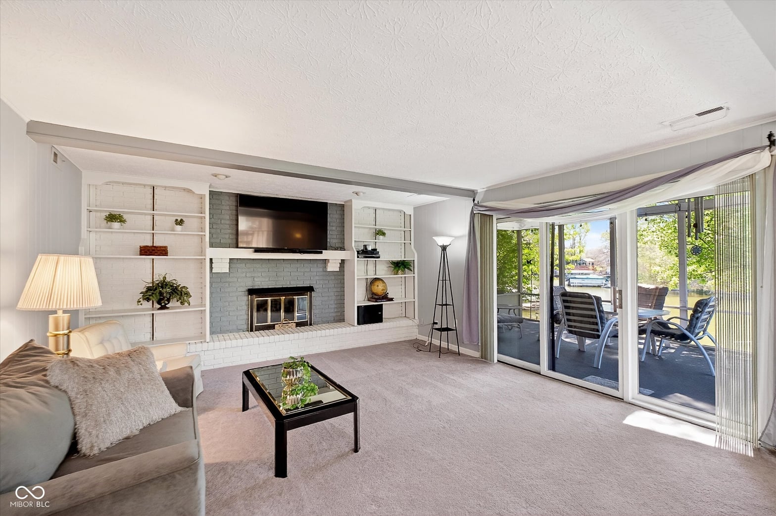 Bright living room with fireplace and outdoor access.
