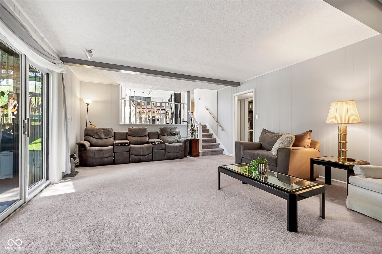 Spacious family room with vaulted ceilings and natural light.